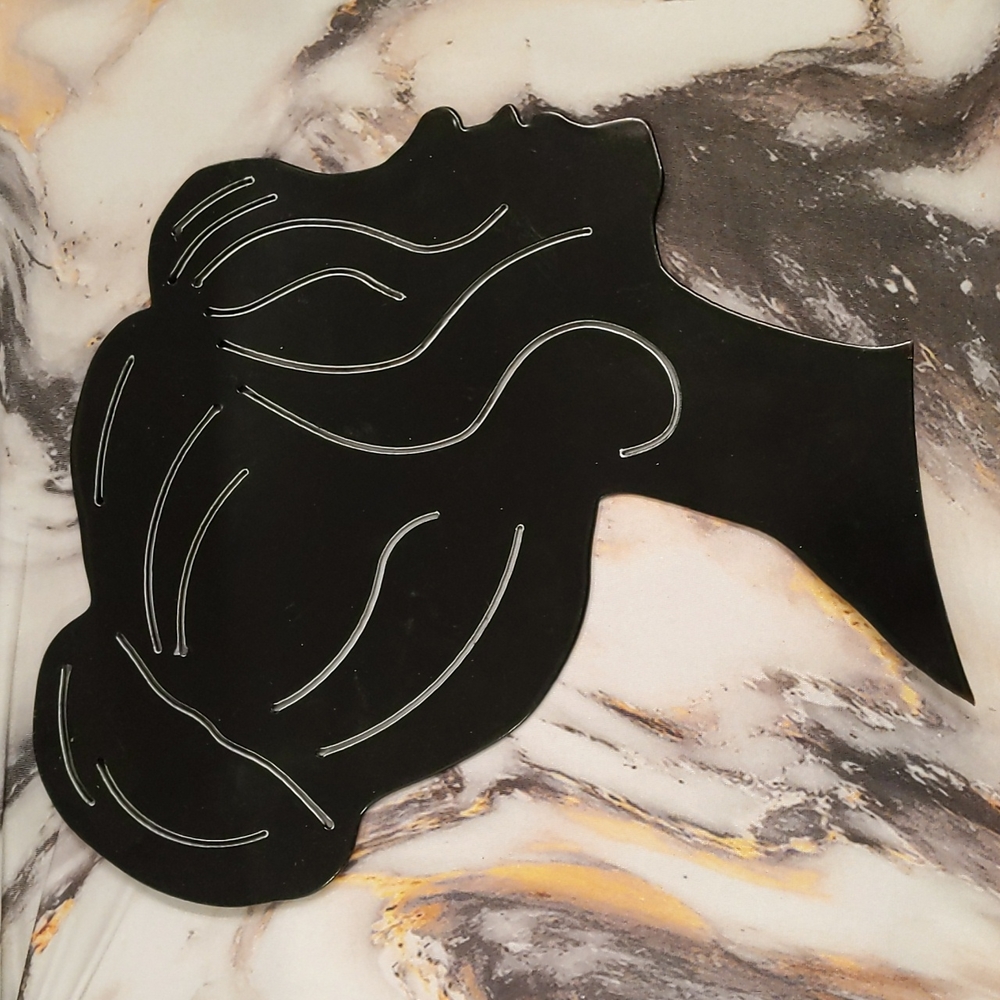 Black silhouette of hair in bun heavy metal material